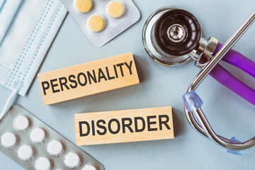 Personality Disorder written on wooden cubes on medical background.