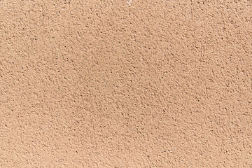 Sunlit wall in salmon tones. Flat surface.