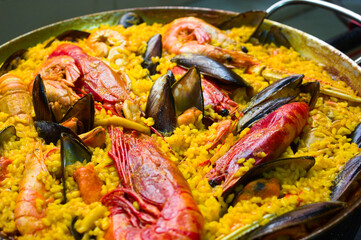 A seafood paella with mussels, prawns and red prawns