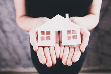 Family care and protection insurance concept. model of a small house