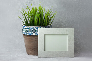 Decoration with photo frame and grass in a pot