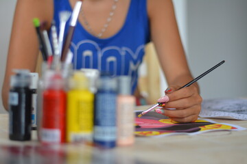 Female artist working with acrylic paint in her art studio