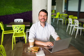 Portrait of a latin guy working during his lunch break