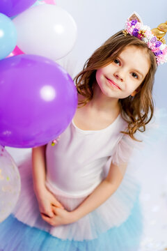 Unicorn Girl posing near air baloons. Idea for decorating unicor