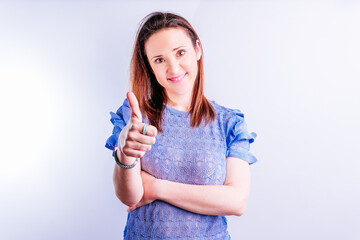 beautiful young woman raising thumb up on white background. approval concept