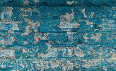 Old cracked brick wall with blue peeling paint
