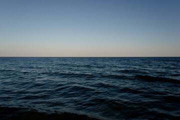 Clear evening sky over the ocean. Theme of travel, romance, vacation, ecology. Modern stylish, copy space.
