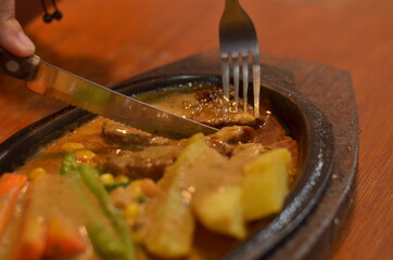 close up of Beef steak with delicious curry and vegetable seasoning