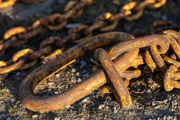 A rusty chain on the beach