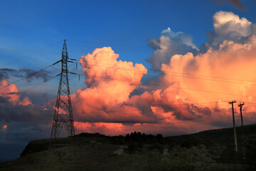 Power line and dramatic cloudy sunset