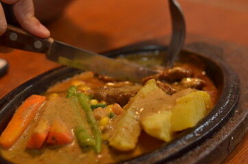 close up of Beef steak with delicious curry and vegetable seasoning