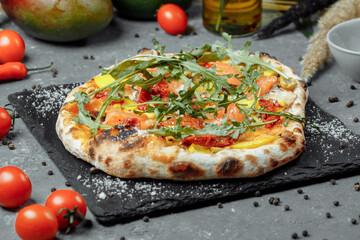 Delicious pizza with salmon and vegetables. italian pizza