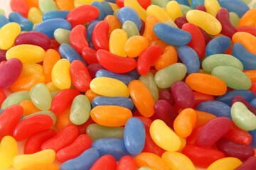 Colorful candy beans as texture and background for design. Close up view of jelly candy beans with selective focus. 