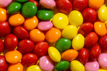 Fototapeta na wymiar Colorful candies in five colors. Top view Flat lay