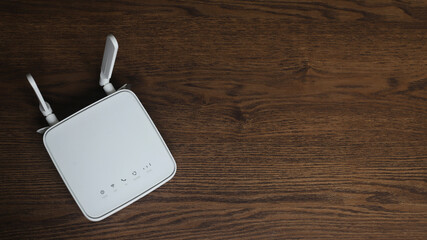 portable residential internet router, white color on wooden table