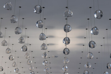 Obraz premium A lot of simple shapes of lamps on the ceiling in a room not at home