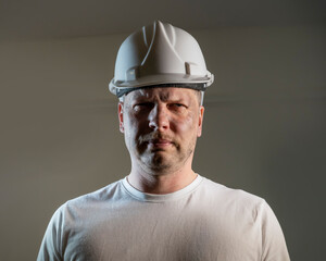 working man construction worker with dirty face looking at camera Close up portrait

