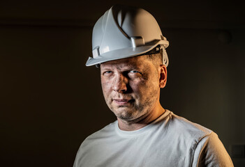 working man construction worker with dirty face looking at camera Close up portrait