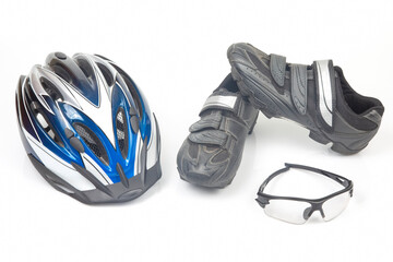 bicycle helmet, glasses and cycling shoes on a white background