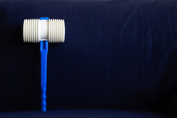 Plastic hammer in blue background. A tradition of the night of Saint John in Portugal. (Martelinho...