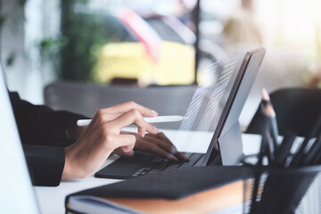 digital technology, Business woman using tablet to trade charts to find buy and sell points for her port.