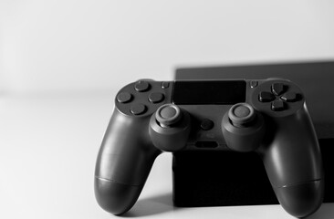 Controls and video game console on light background