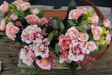 Brown rattan bag handmade and pink rose artificial flowers