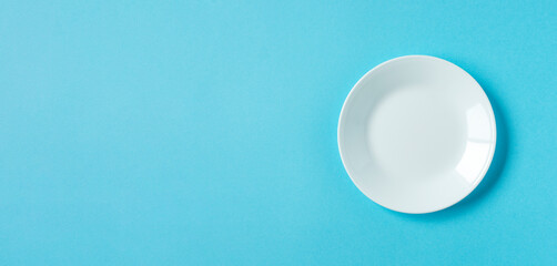 White plate on light blue background.  水色背景上の白いお皿