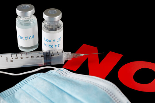 Covid 19 Vaccine Bottles With Needle And Syringe On A NO Sign