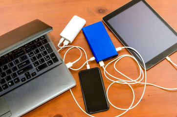 Charge sharing: recharging a laptop, a cellphone and a tabled with two power banks