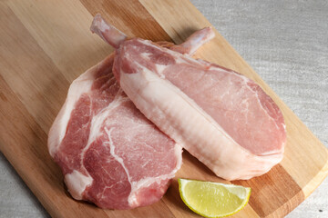 Raw pork meat on a cutting board.