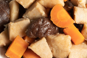 Close up of cooked carrots, yams and shiitake .