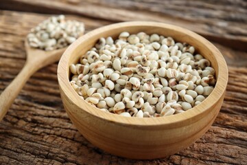 White millet seed raw in wood bowl on table