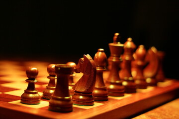  Eloquent view from behind chess pieces on chess board with corner in focus