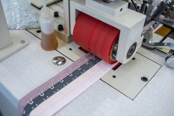 Fully automatic bra back button machine in the production workshop of underwear factory