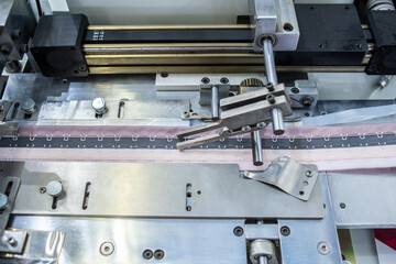 Fully automatic bra back button machine in the production workshop of underwear factory
