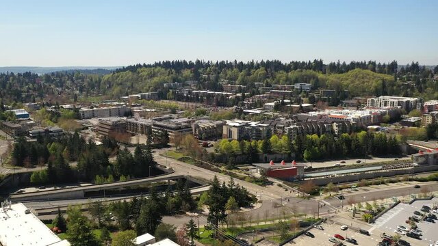 Cinematic aerial drone dolly footage of downtown Mercer island, shopping plaza, Mcgilvara, Mercer Island Town, residential and commercial areas, luxury homes by Lake Washington, near Seattle