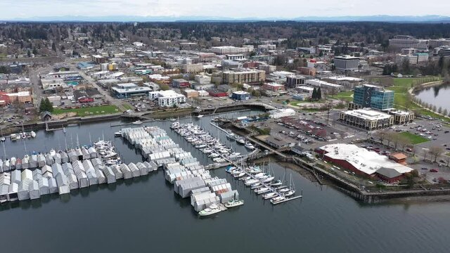 Cinematic aerial drone footage of the Olympia Yacht Club near the Washington State Capitol Building and Campus, Capitol Lake, with a panoramic view of Historic District in Olympia, Washington