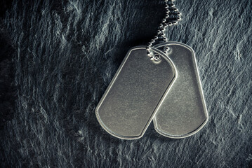 American military dog tags. Rough and worn with blank space for text. Memorial Day or Veterans Day concept.