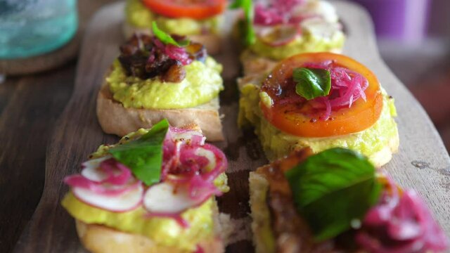 Plant based varieties of appetizers. Healthy colorful vegan bruschettas with spreads and fresh vegetables