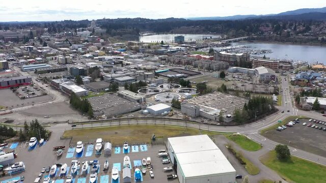 Cinematic aerial drone footage of the commercial district of downtown Olympia, Capitol Lake, West Bay, with a panoramic view of Historic District and the Capitol Building in Olympia, Washington