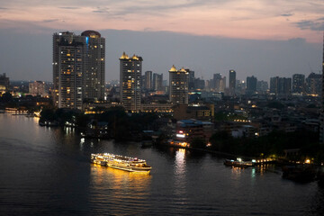 Fototapeta na wymiar The river cruise dinner service at the Chao Phraya River in Bangkok, Thailand.