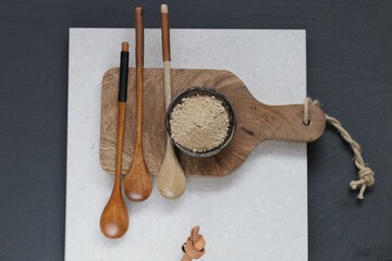  Guarana powder. Natural energetic.Guarana powder in a ceramic plate and wooden spoons on a white...