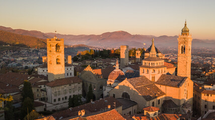 Fototapeta na wymiar Bergamo, Italy. Amazing drone aerial view of the Old city. One of the beautiful city in Italy. Landscape at the city center and the historical buildings during sunset