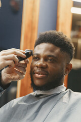 Young African-american man visiting barbershop