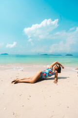 Fototapeta na wymiar A woman relaxing on the beach in summer