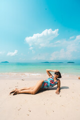 Fototapeta na wymiar A woman relaxing on the beach in summer