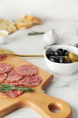 Composition with tasty salami on table