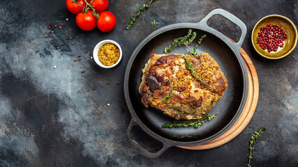 roasted pork loin. large piece of baked pork with mustard on a cutting board. Festival food. Long...