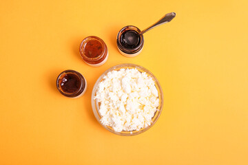 Grainy cottage cheese in bowl with different jams